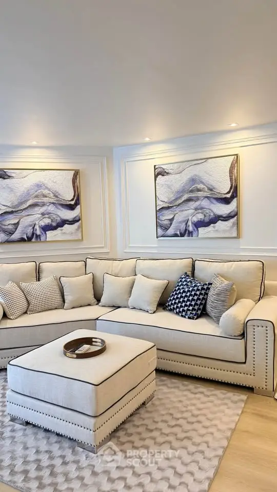 Elegant living room with plush sofa and modern art decor, perfect for stylish relaxation.