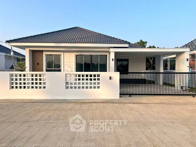Modern single-story house with sleek design and spacious front yard