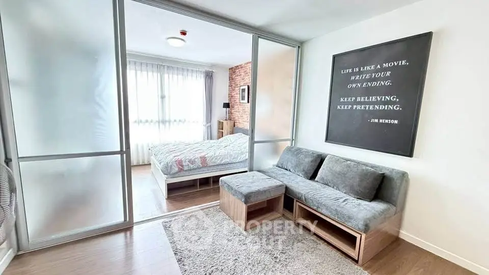 Modern studio apartment with sliding glass doors and cozy living area