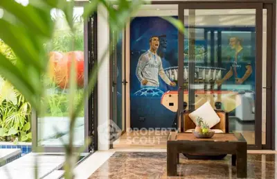 Luxurious living room with pool view and sports-themed decor