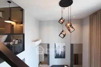 Modern loft-style living room with unique pendant lighting and stylish decor.