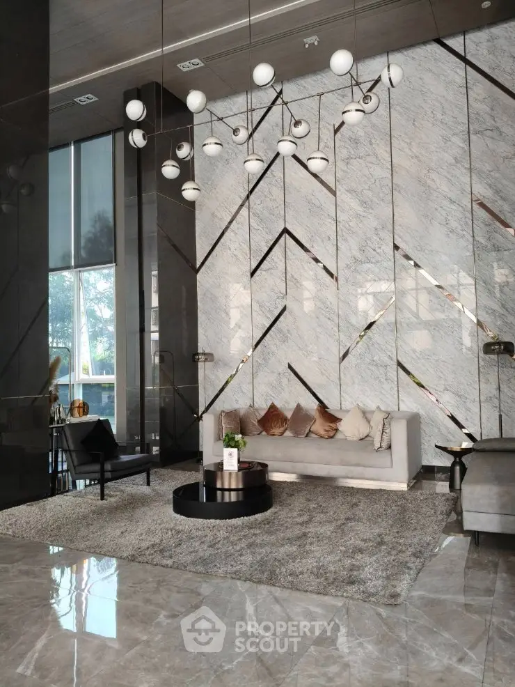 Luxurious modern living room with elegant chandelier and marble accents