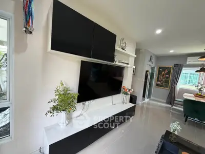 Modern living room with sleek black and white entertainment unit and stylish decor