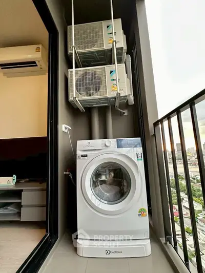 Modern balcony with washing machine and city view, perfect for urban living convenience.