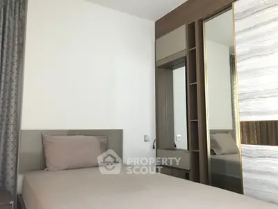Modern bedroom with sleek design and built-in wardrobe, perfect for urban living.
