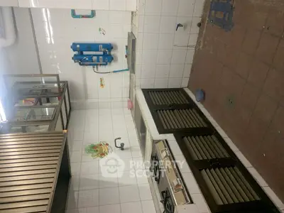Spacious kitchen with gas stove and ample storage in modern apartment