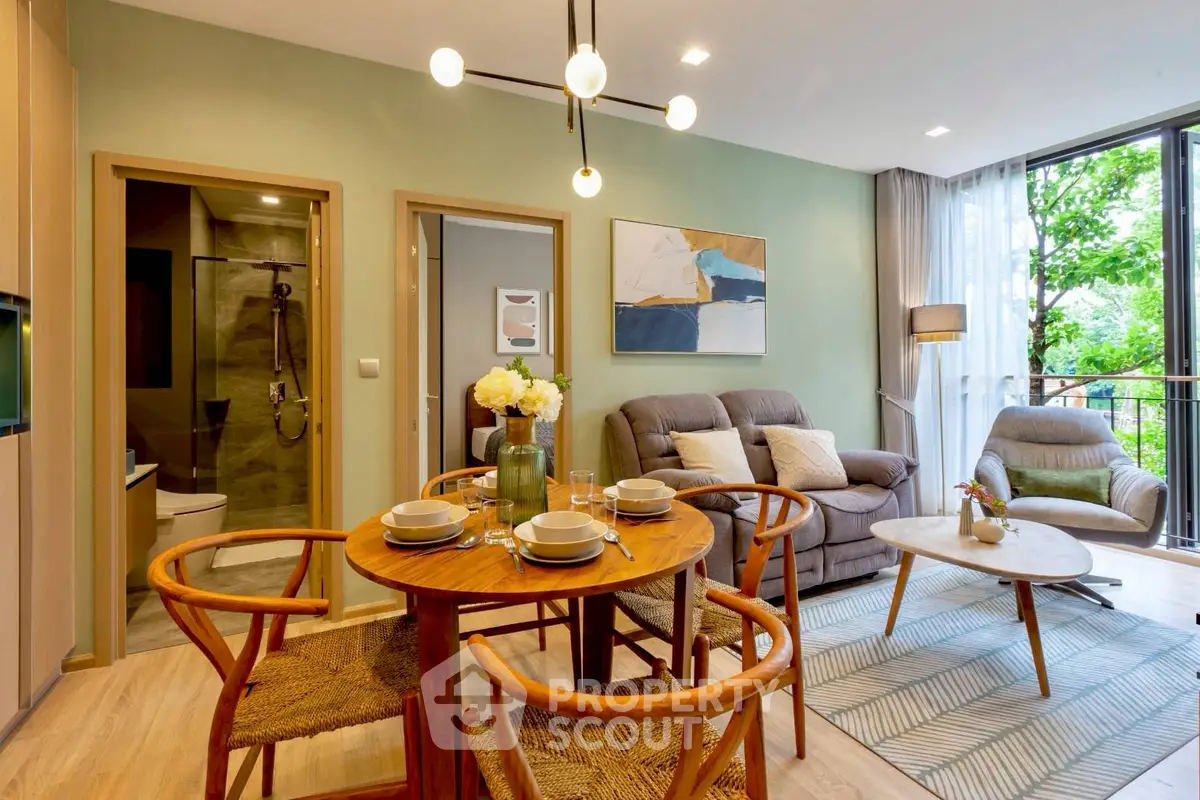 Modern living room with stylish furniture and large windows overlooking greenery.