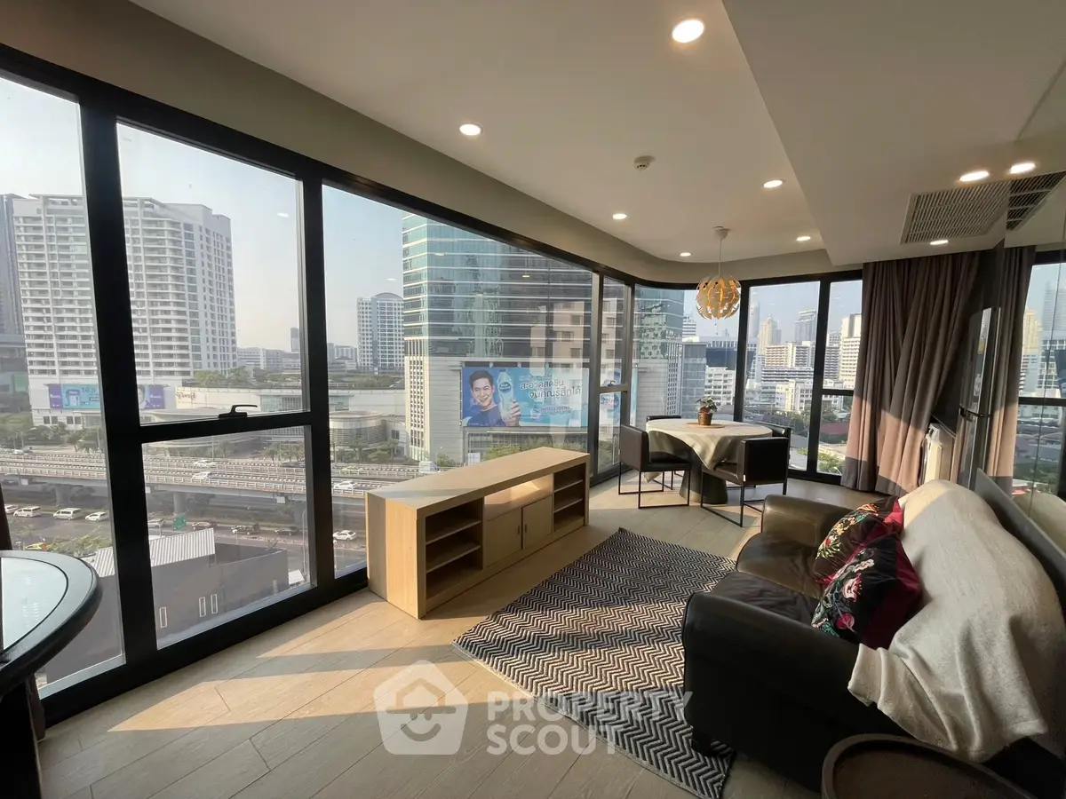 Stunning corner unit living room with panoramic city views and modern furnishings.