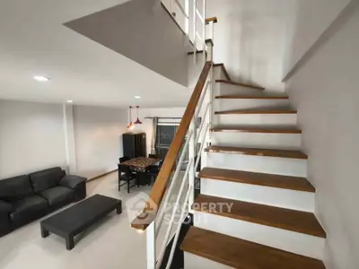 Modern living room with staircase and stylish furniture
