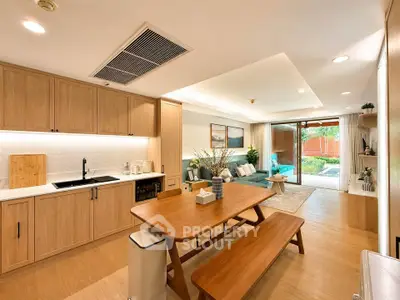 Spacious open-plan living room with modern kitchen and garden view, perfect for family gatherings.