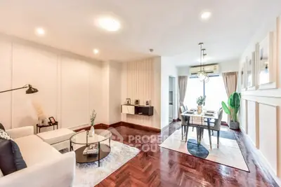 Spacious living and dining area with modern decor and hardwood floors.