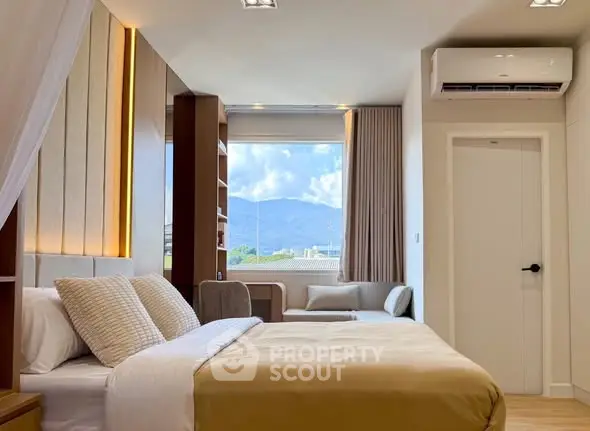 Luxurious bedroom with mountain view, modern decor, and ample natural light.