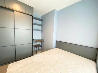 Modern bedroom with built-in wardrobe and study desk in a stylish apartment.