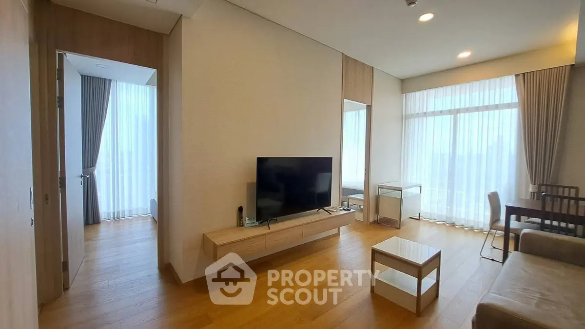 Spacious modern living room with large windows and elegant wooden flooring