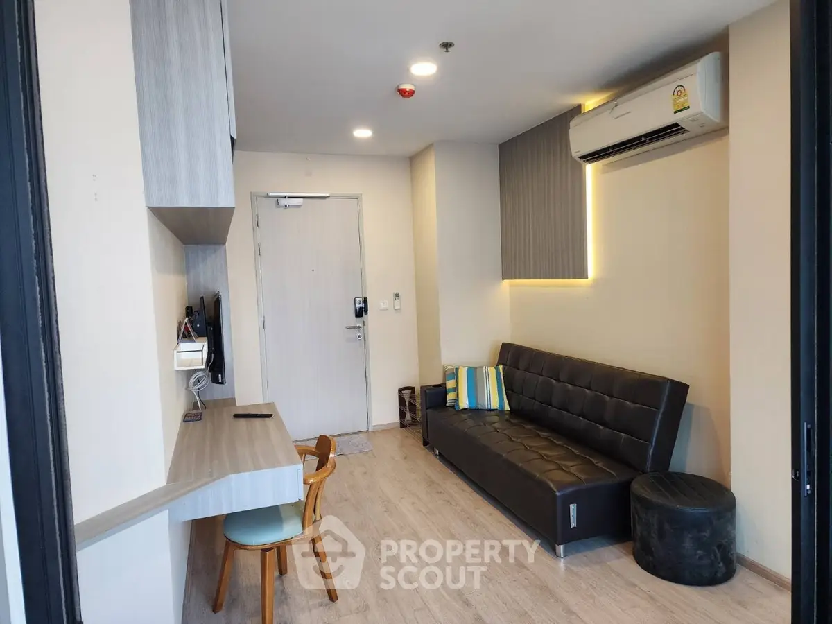 Modern living room with sleek furniture and air conditioning in a cozy apartment.