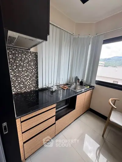 Modern kitchen with sleek cabinets and scenic window view