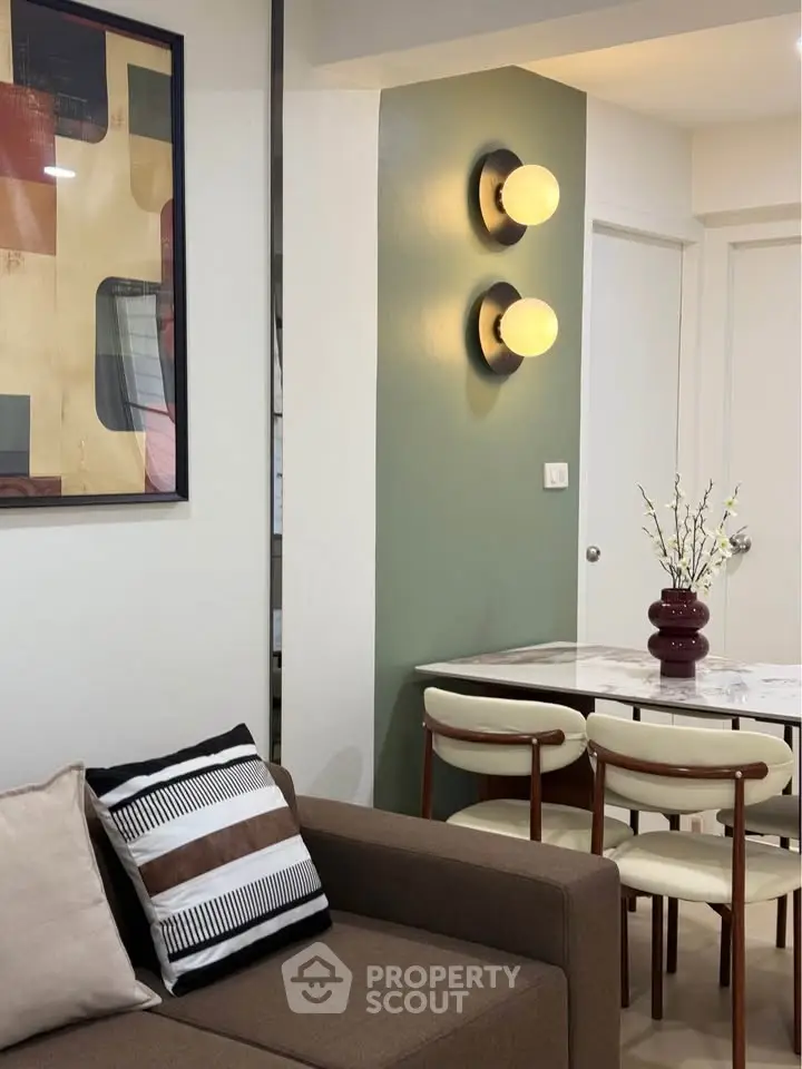 Stylish modern living room with elegant dining area and contemporary wall art.