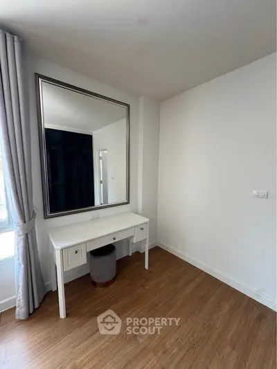 Elegant bedroom corner with large mirror and stylish vanity table