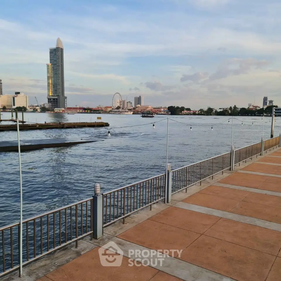 Stunning riverside view with modern skyline and ferris wheel in the distance