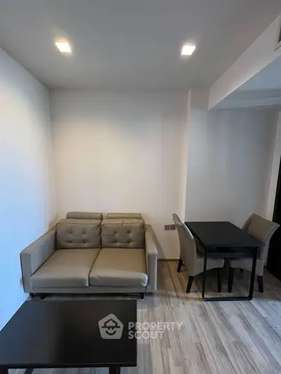 Modern living room with cozy sofa and dining area in a stylish apartment.