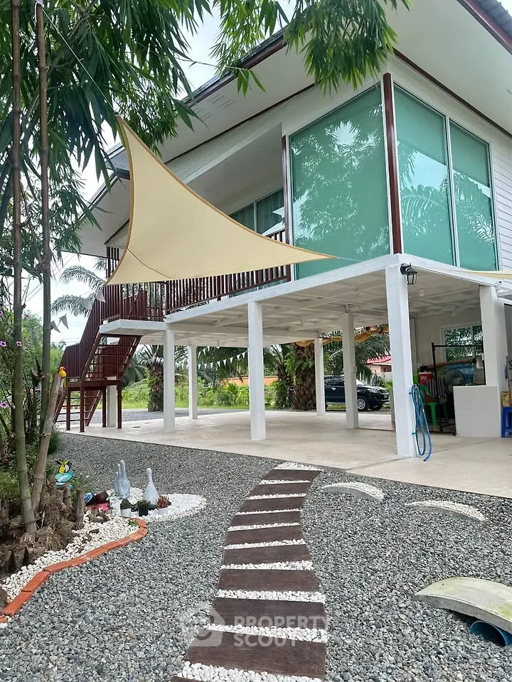 Modern two-story house with stylish exterior and landscaped garden pathway.