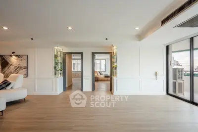 Spacious modern living room with elegant decor and large windows