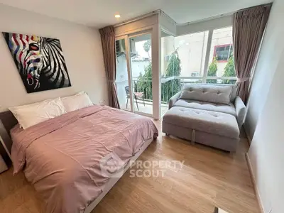 Cozy bedroom with stylish decor and balcony view in modern apartment