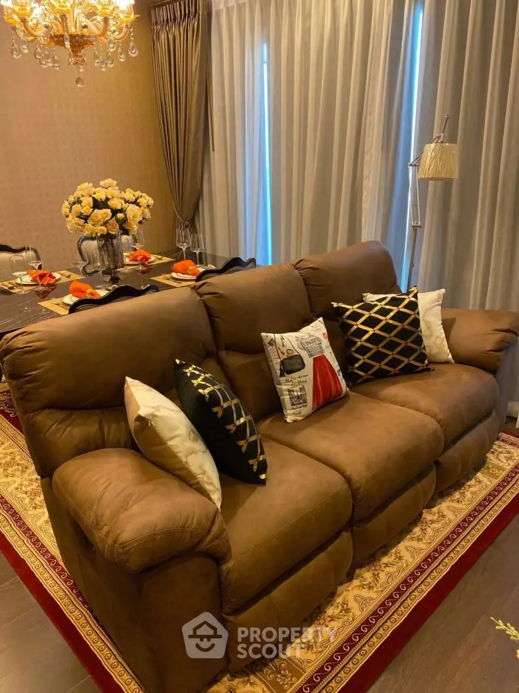 Luxurious living room with plush brown sofa and elegant dining setup, perfect for entertaining.