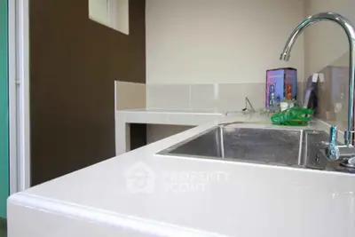 Modern kitchen with sleek countertops and stainless steel sink