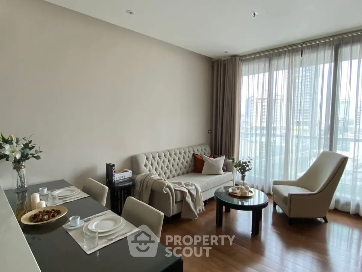 Elegant living room with modern decor and city view, featuring plush seating and dining area.