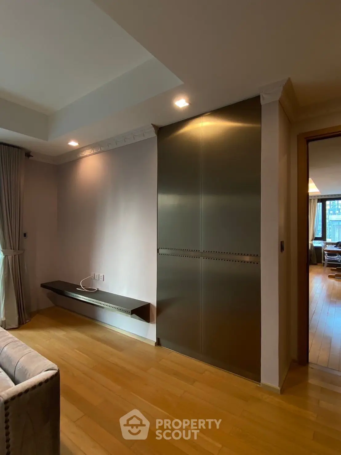 Modern living room with sleek metal storage and wooden flooring