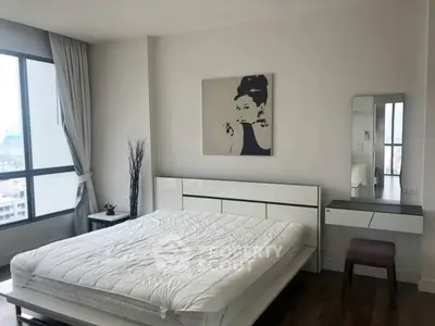 Modern bedroom with large windows and stylish decor in a high-rise apartment.