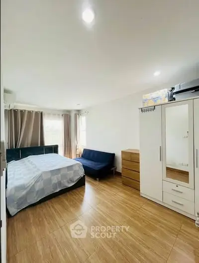 Spacious bedroom with modern furnishings and natural light