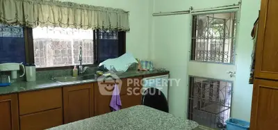 Charming kitchen with granite countertops and ample natural light, featuring a dishwasher and cozy dining area.