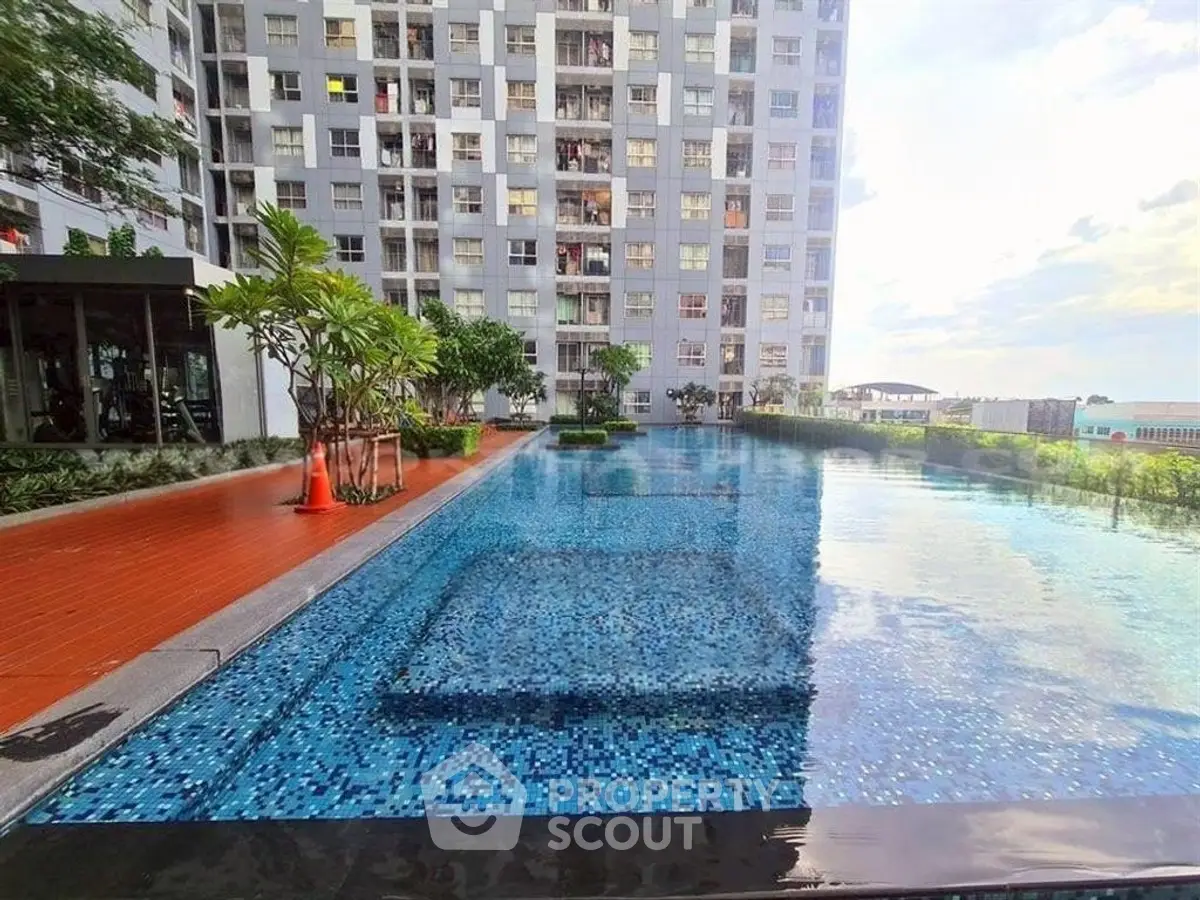 Luxurious high-rise building with stunning outdoor pool and lush greenery.