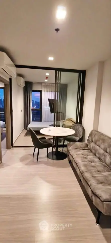 Modern living room with stylish furniture and city view balcony