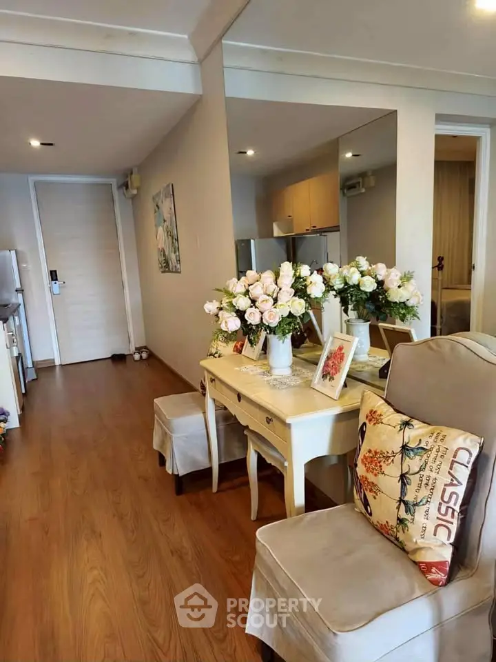 Charming living room with elegant decor and wooden flooring in modern apartment.