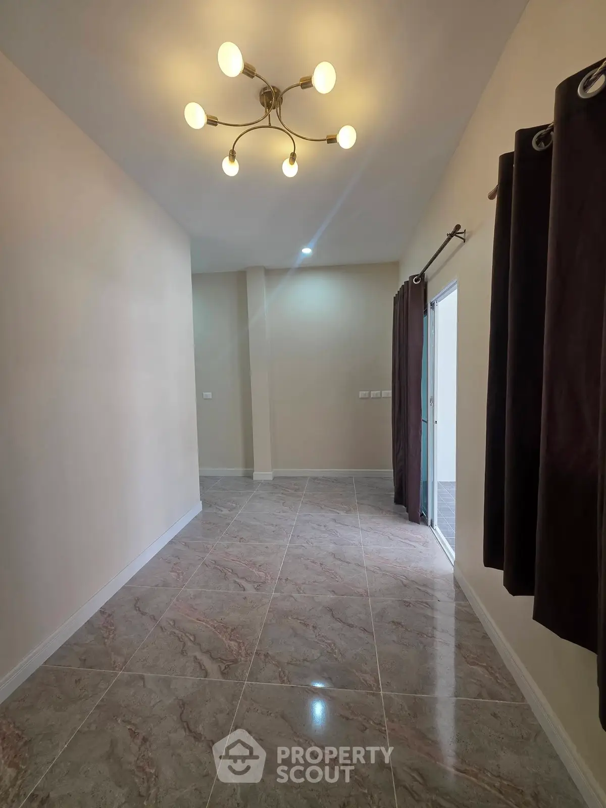 Spacious hallway with elegant lighting and tiled flooring in modern home