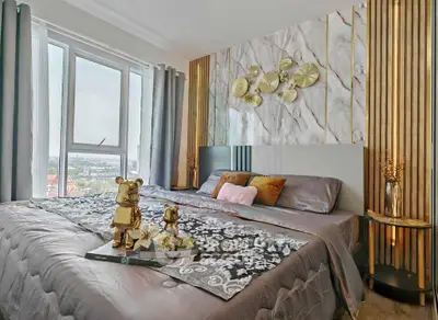 Luxurious bedroom with elegant decor and large window offering stunning city views.