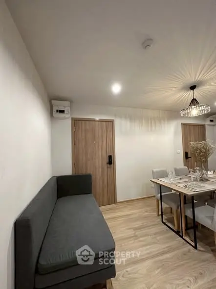 Modern dining area with stylish lighting and cozy seating in a contemporary apartment.