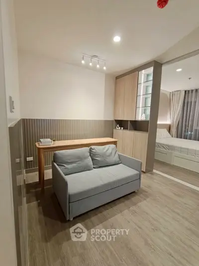 Modern studio apartment with cozy living area and stylish bedroom