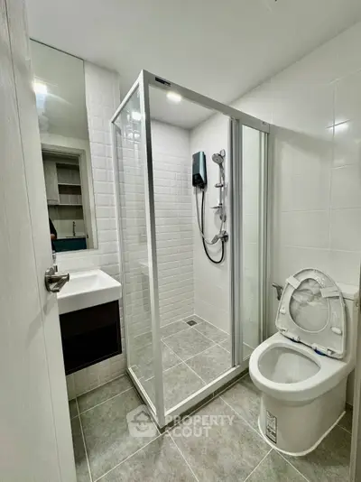 Modern bathroom with glass shower enclosure and sleek fixtures