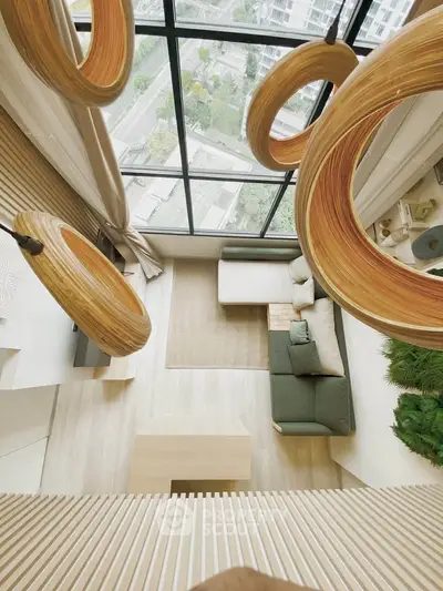 Stunning modern living room with floor-to-ceiling windows and unique wooden light fixtures.