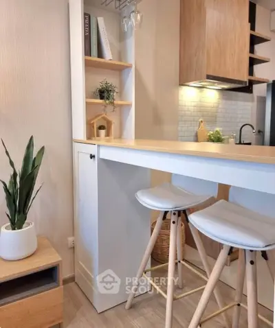 Modern kitchen with stylish bar stools and wooden accents