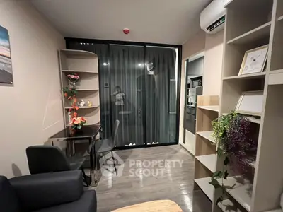 Modern living room with stylish decor and open kitchen view, perfect for urban living.