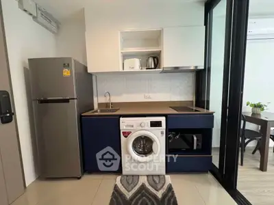 Modern kitchen with washing machine and sleek appliances in compact layout