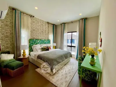 Luxurious bedroom with stylish decor, featuring a plush bed, elegant wallpaper, and vibrant accents for a cozy retreat.