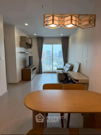 Modern living room with city view, stylish furniture, and elegant lighting in a high-rise apartment.