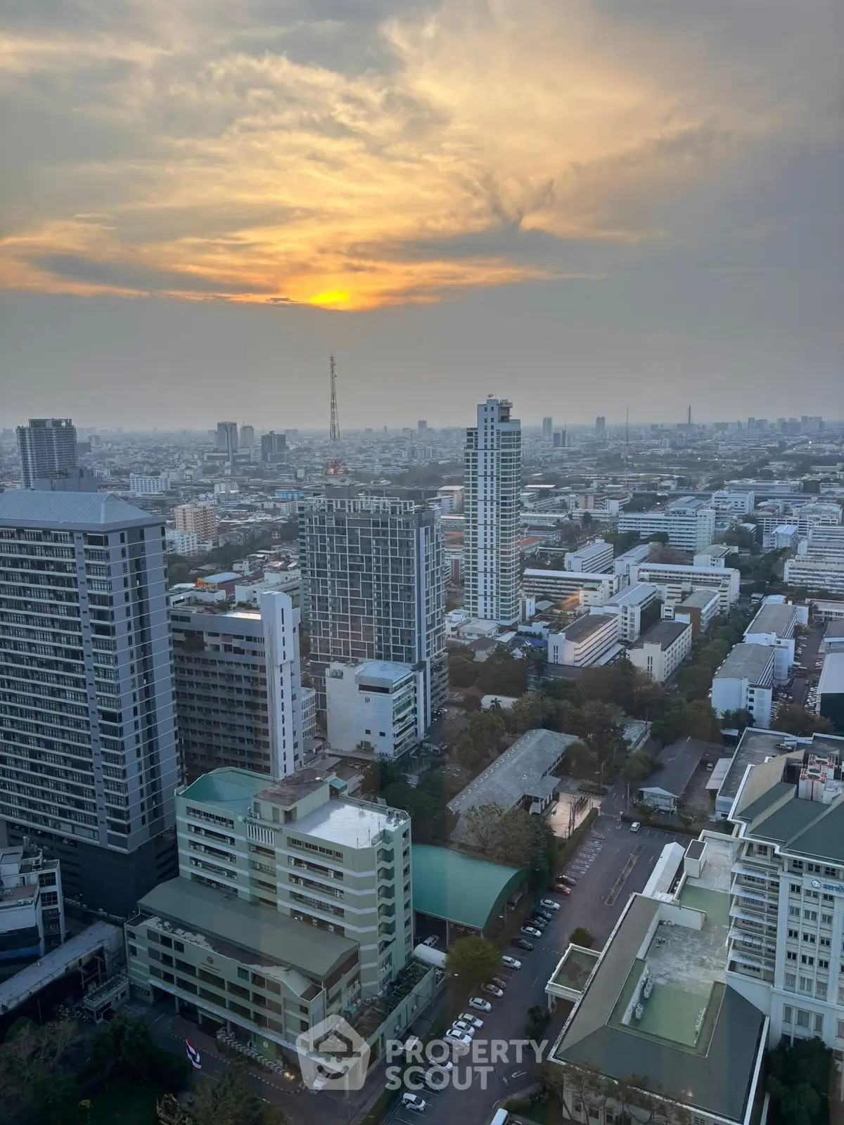 Stunning cityscape view from high-rise building at sunset, showcasing urban skyline and vibrant city life.
