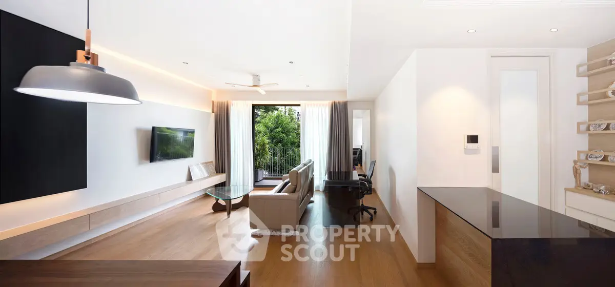 Modern open-plan living room with sleek design and garden view balcony.